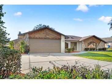 Charming single Gathering home featuring a two car garage and well maintained landscaping at 1011 Altoona Ave, Spring Hill, FL 34609