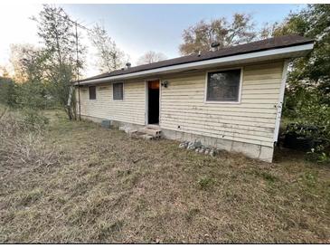 Exterior view of a house with light siding and neglected landscaping at 13140 Moon Rd, Brooksville, FL 34613