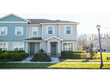 Charming townhome with a well-manicured lawn and beautiful landscaping at 15384 Caravan Ave, Odessa, FL 33556