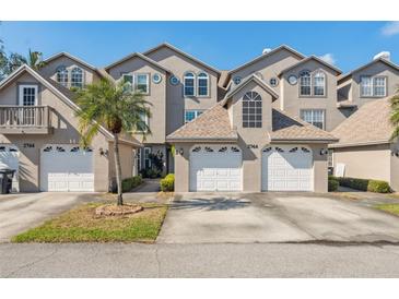 Townhouse exterior showcasing multi-car garages, stucco facades, manicured landscaping and architectural design at 2764 Countryside Blvd # 3, Clearwater, FL 33761