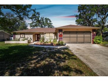 Charming single-story home featuring well-maintained landscaping and an attached two-car garage at 3273 Bluestone Ave, Spring Hill, FL 34609