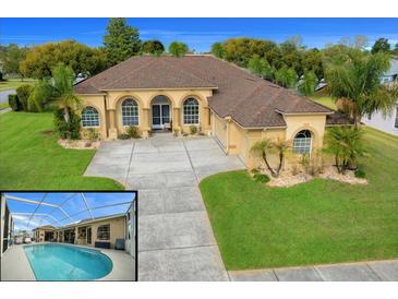 Stunning home with a large driveway, arched entryway, tropical landscaping, and a refreshing screened-in pool at 3542 Conifer Loop, Spring Hill, FL 34609