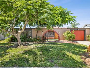 Charming single-story home with a gated entrance and lush green lawn at 3730 Sail Dr, New Port Richey, FL 34652