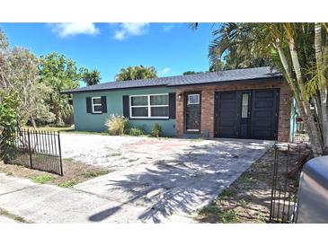 Charming single-story home with a brick front door, dark shutters, and palm tree landscaping at 506 8Th Ave Sw, Largo, FL 33770