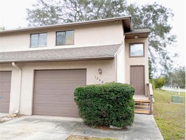 Charming townhouse featuring an attached garage and a cozy front entrance at 12401 Joel Ct, Tampa, FL 33612