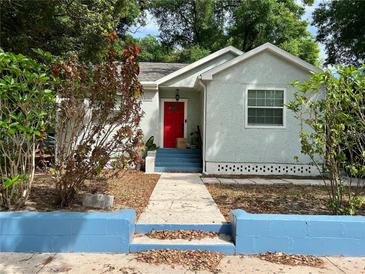Charming single-story home with a vibrant red front door and a well-maintained walkway at 4009 N Seminole Ave, Tampa, FL 33603