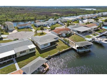 Waterfront homes featuring private docks and boat lifts for easy access to the water at 6627 Leeside Isle, Hudson, FL 34667