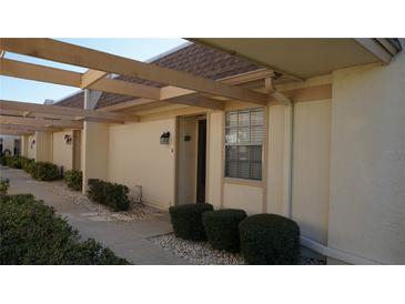 Charming condo features a covered entryway, well-maintained landscaping, and a welcoming front door at 11140 Carriage Hill Dr # 3, Port Richey, FL 34668