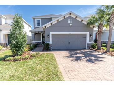 Charming two-story home with well-manicured lawn, paved driveway and a two-car garage at 2830 Dudley Ave, Odessa, FL 33556