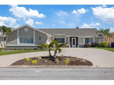 Charming single-story home with stone accents, mature landscaping, and a circular driveway at 5000 Galleon Ct, New Port Richey, FL 34652
