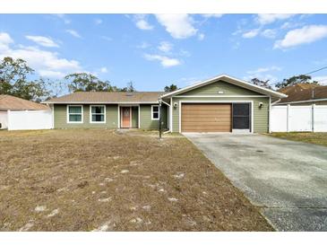 Charming single-story home featuring a well-maintained lawn and a convenient attached garage at 5441 Alderwood St, Spring Hill, FL 34606