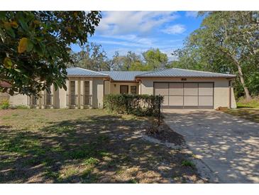 Charming single-story home featuring a spacious driveway and low maintenance landscaping at 6259 Hillview Rd, Spring Hill, FL 34606