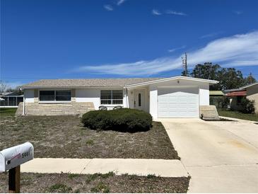Charming single-story home with a well-maintained front yard and attached one car garage at 5441 Mosaic Dr, Holiday, FL 34690