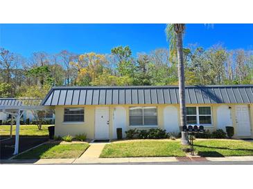 Charming townhouse with a covered parking spot and a well-maintained lawn at 11817 Bayonet Ln, New Port Richey, FL 34654