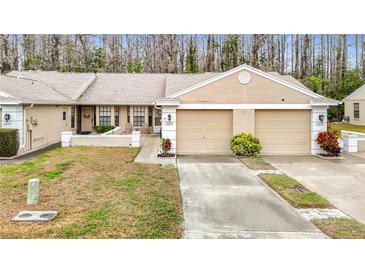 Inviting single story home with two car garage, neutral paint, and well-manicured lawn in a desirable community at 13227 Molitor Ct, Hudson, FL 34669