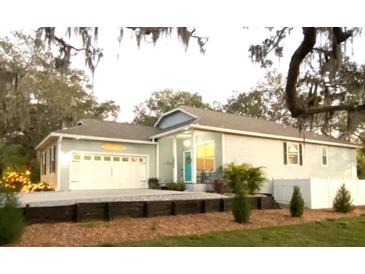 Charming single-Gathering home featuring an attached garage, well-maintained landscaping, and a welcoming front porch at 513 Meres Blvd, Tarpon Springs, FL 34689