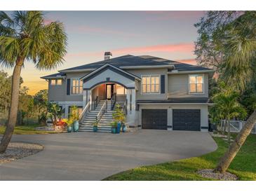 Stunning two-story home featuring a grand entrance, two-car garage, and lush landscaping at 625 Lafayette Blvd, Oldsmar, FL 34677