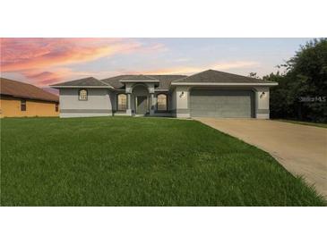 Charming single-story home with a well-maintained lawn and attached two-car garage at 10056 Lebanon Dr, Port Charlotte, FL 33981
