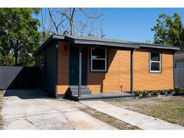 A charming single-story home with a two-tone exterior and a well-maintained front yard at 4601 N 37Th St, Tampa, FL 33610