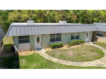 Charming single-story home with a well-maintained lawn and walkway leading to the front door at 11917 Bayonet Ln # 11917, New Port Richey, FL 34654