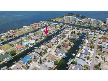 Stunning aerial view of waterfront neighborhood with canal access and boats docked at private residences at 13610 Claudia Dr, Hudson, FL 34667