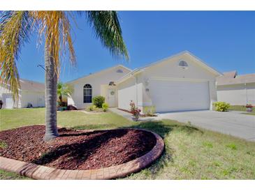 Charming single-story home with manicured lawn, palm tree, and two-car garage at 4429 Whitton Way, New Port Richey, FL 34653