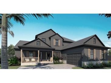 Inviting gray two-story home with a charming front porch, a well-manicured lawn, and attached garage at 4611 Hickory Oak Dr, Brooksville, FL 34601