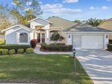 Charming single-story home featuring a well-manicured lawn and a two-car garage at 11339 Alden Ct, Hudson, FL 34667