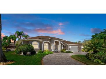 Beautiful single-story home with a paved driveway and well-manicured landscaping at 2375 Fairskies Dr, Spring Hill, FL 34606