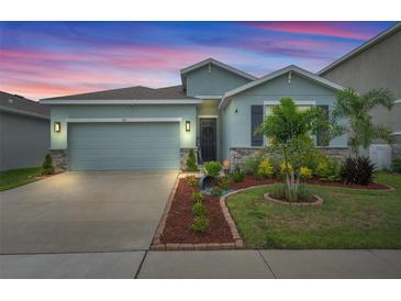 Charming single-Gathering home featuring a two-car garage and well-manicured landscaping at 582 8Th Nw St, Ruskin, FL 33570