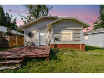 Charming single-story home featuring a cozy front deck and freshly cut lawn at dusk at 4725 3Rd S Ave, St Petersburg, FL 33711