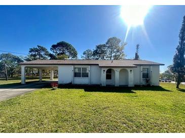 Charming single story home featuring a carport and a well-maintained front yard at 6012 Landover Blvd, Spring Hill, FL 34609