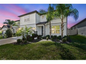 Charming two-story home featuring a landscaped yard and mature palm trees, providing curb appeal at 778 Parsons Mooring Ct, Seffner, FL 33584
