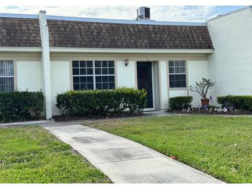 Charming single-story home with well-maintained lawn and updated windows at 11310 Carriage Hill Dr # 4, Port Richey, FL 34668