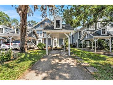Charming townhomes feature covered parking and well-maintained landscaping in a serene, tree-lined neighborhood at 290 Winchester Way, Palm Harbor, FL 34684