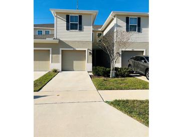 Inviting townhomes featuring attached garages, neutral paint, and well-maintained landscaping at 3037 Jacob Crossing Ln, Holiday, FL 34691