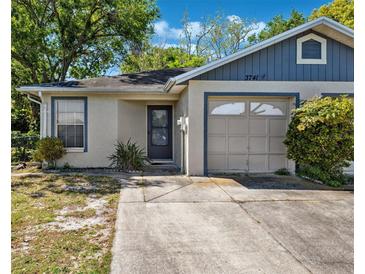 Charming single-story home featuring a front yard and attached garage on a sunny day at 3741 Appleton Ct, Palm Harbor, FL 34684