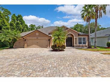 Charming single-Gathering home with a spacious driveway and well-maintained landscaping, including palm trees at 7925 Calindra Ct, Trinity, FL 34655