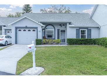 Charming single-story home featuring well-manicured lawn and attached one-car garage at 9348 Villa Entrada, New Port Richey, FL 34655