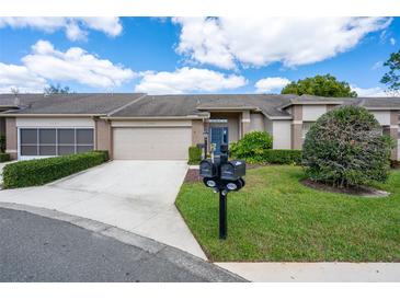 Charming home with a well-maintained front yard and a two-car garage at 3160 Whispering Pines Ct, Spring Hill, FL 34606
