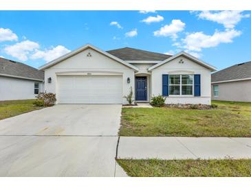 Charming single-story home featuring a two-car garage, well-maintained lawn, and inviting curb appeal at 4004 Autumn Amber Dr, Spring Hill, FL 34609