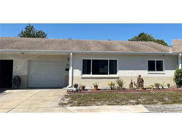 Charming single-story home features a well-maintained front yard, attached garage, and a neutral stucco exterior at 4653 Cambridge Ave # 4653, New Port Richey, FL 34652