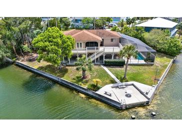 Waterfront home with elevated deck, screened pool, and dock for enjoying scenic views at 3415 Holly Springs Dr, Hernando Beach, FL 34607