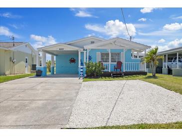 Charming coastal-style home with a front porch and a spacious driveway, perfect for relaxing at 4400 Floramar Ter, New Port Richey, FL 34652