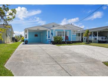 Charming blue home with a large driveway, carport, and a decorative nautical theme at 4400 Floramar Ter, New Port Richey, FL 34652