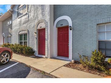 Charming townhome entrance with brick facade, arched doorways, and well-maintained landscaping at 5651 Townhouse Dr # 5651, New Port Richey, FL 34652