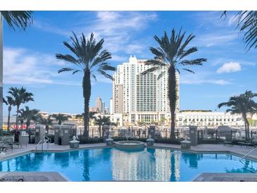 Resort style pool deck with palm trees and views of downtown at 700 S Harbour Island Blvd # 413, Tampa, FL 33602
