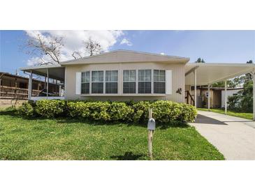Charming mobile home with well-manicured lawn and carport at 846 Oakwood Dr, Tarpon Springs, FL 34689