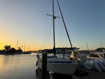 Docked sailboat with sunset colors reflecting on the water at 4678 Marine Pkwy # 305, New Port Richey, FL 34652