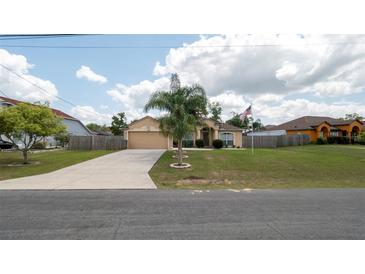 Charming single-story home featuring a well-maintained lawn, long driveway, and a welcoming facade at 5092 Roble Ave, Spring Hill, FL 34608